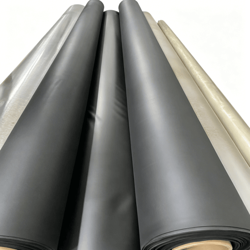 Multiple large rolls of black EVA interlayer film stored in an industrial facility.