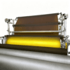 Industrial laminating machine processing a brown tinted EVA interlayer film.